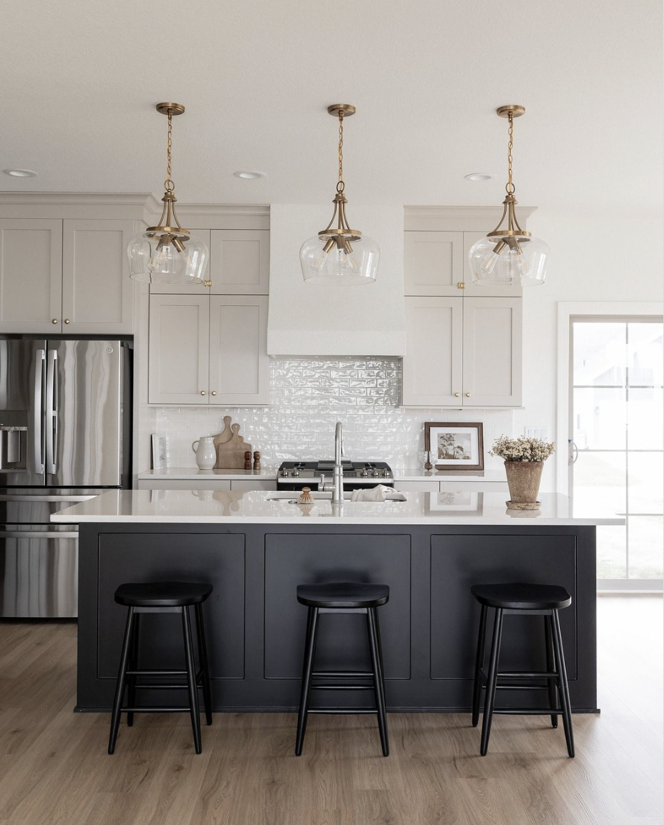 White Kitchen Featuring a Black Island