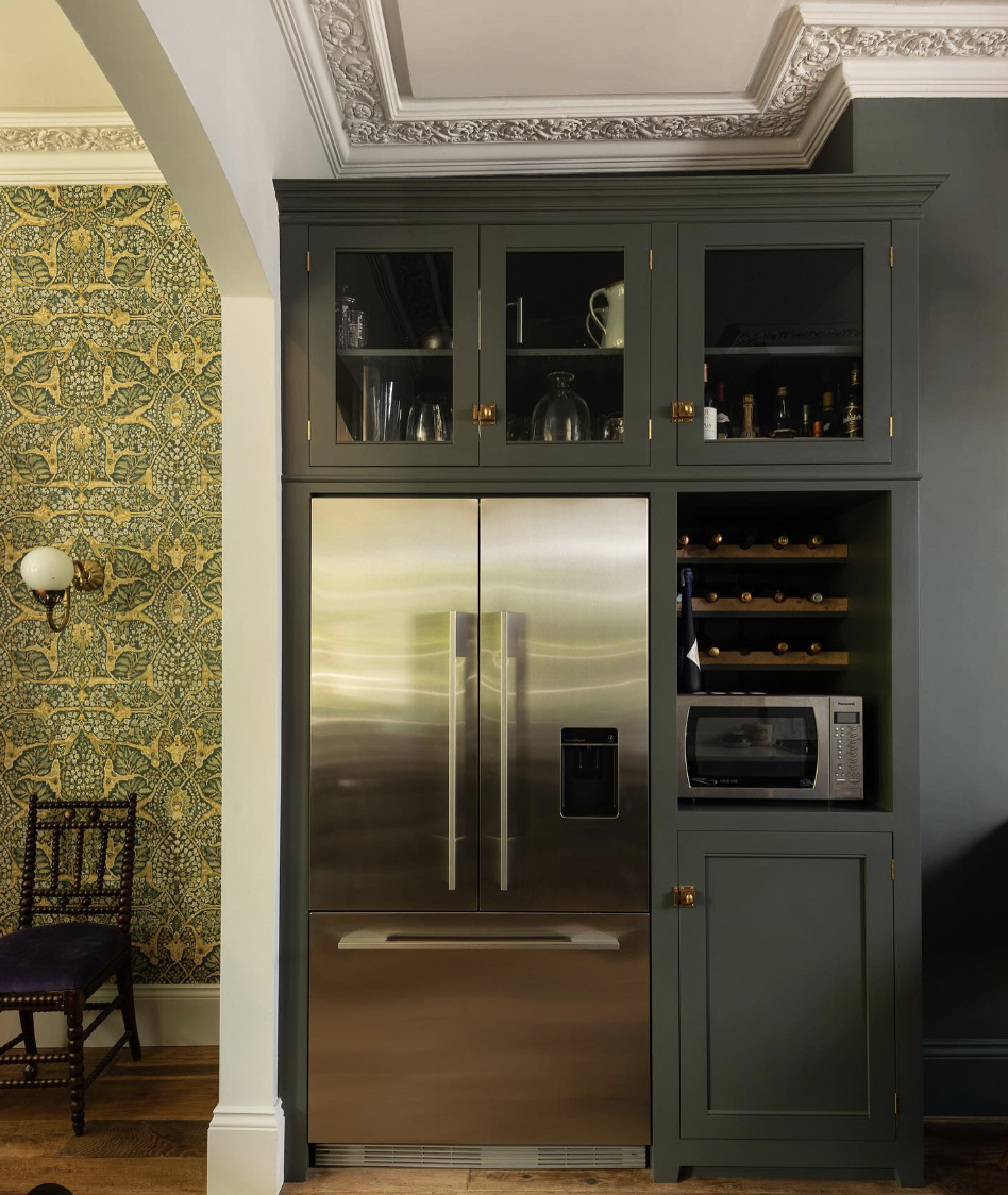 Brass-Accented Forest Green Cabinet Over the Refrigerator