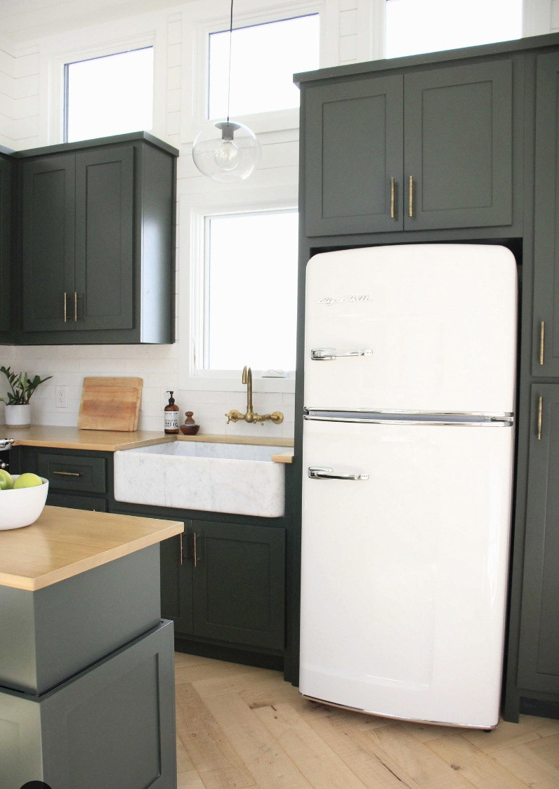 Deep Green Cabinets Over a White Refrigerator