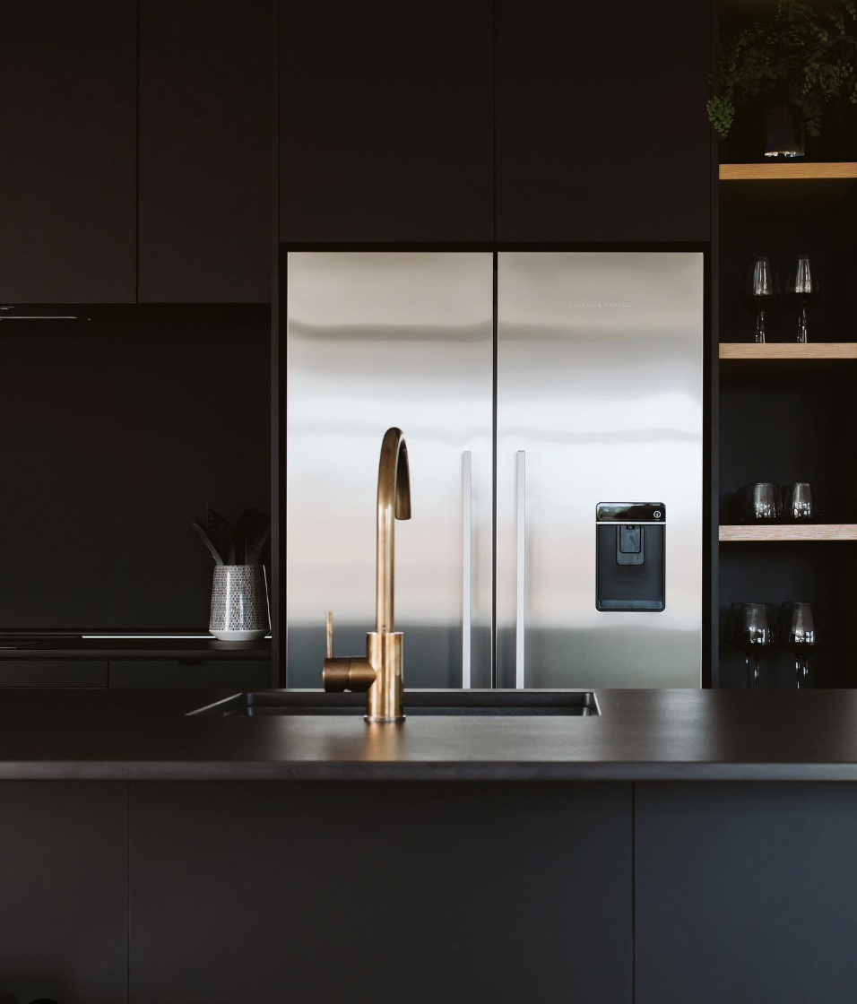 Black Cabinets and Floating Shelves Over the Refrigerator