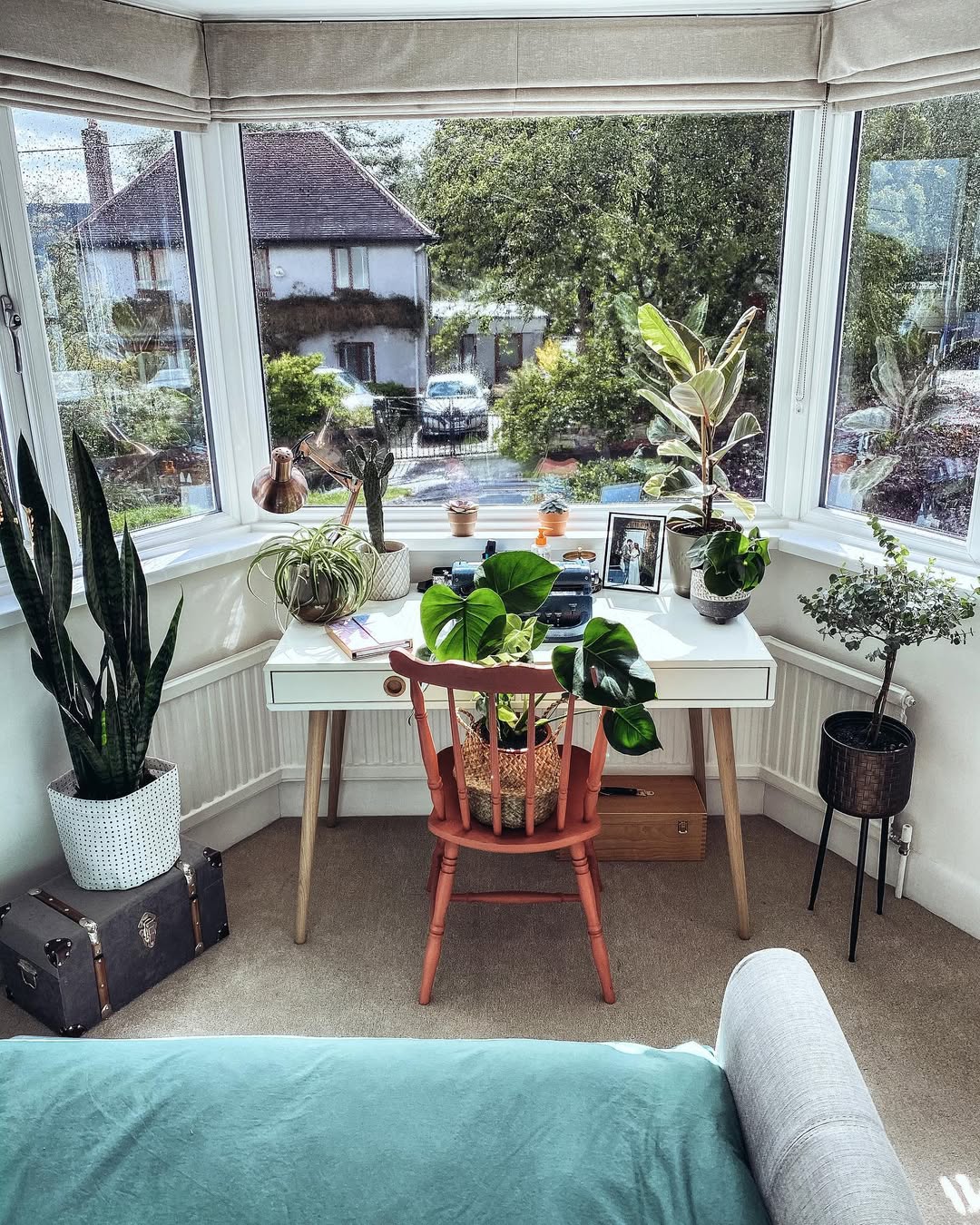 Bay Window Desk Surrounded by Plants