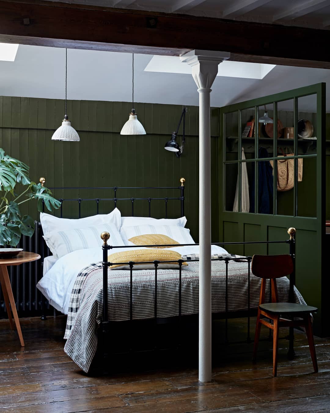 Olive Paneling And a Classic Metal Bed