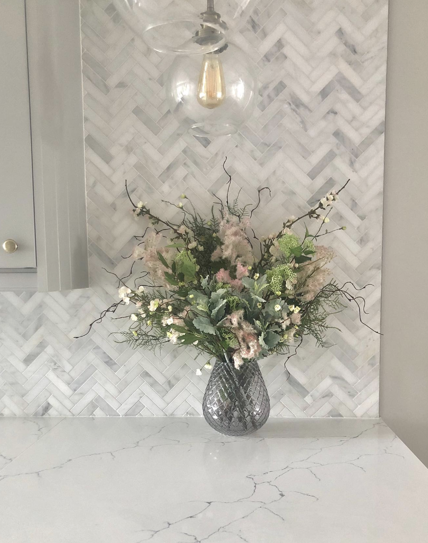Marble Countertops With a White and Grey Small-Tile Herringbone Backsplash