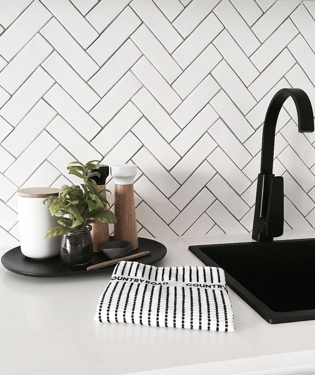White Herringbone Tile Feature Wall With Black Hardware