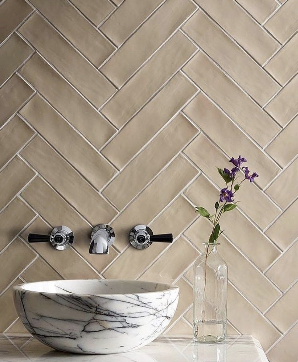 Light Brown Herringbone Backsplash and Marble Sink