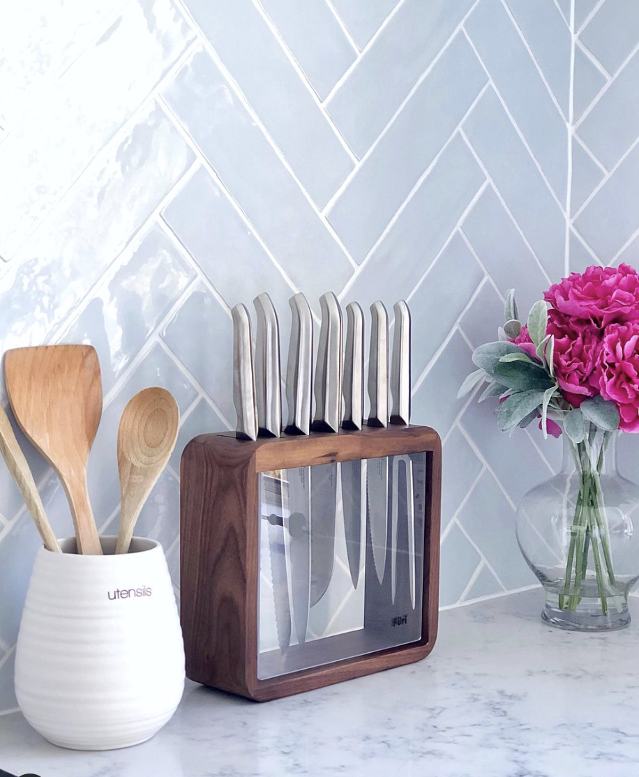 Light Grey Kitchen Backsplash in a Herringbone Layout With White Grout