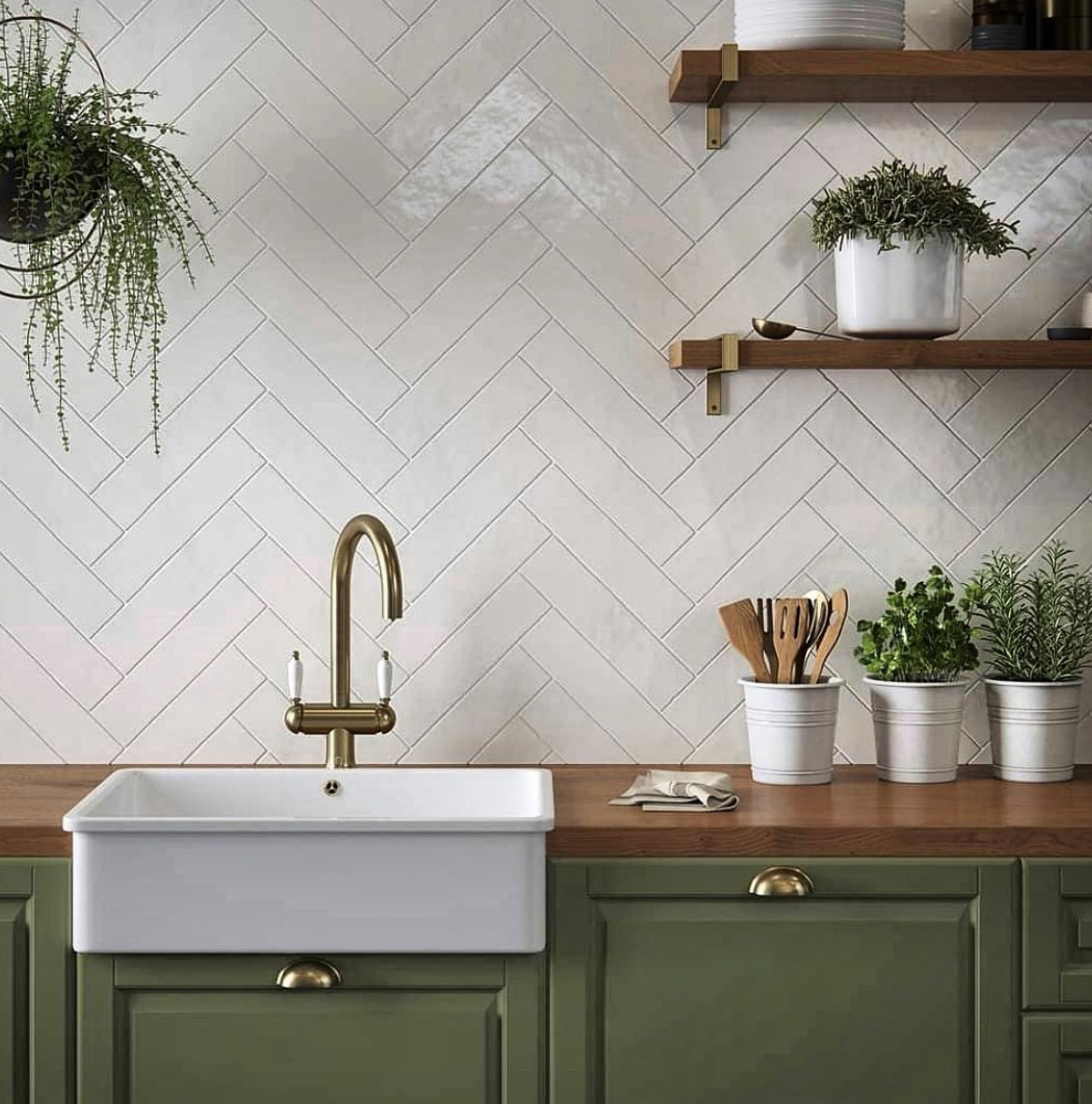 Green Cabinet Kitchen With a White Herringbone Tile Backsplash