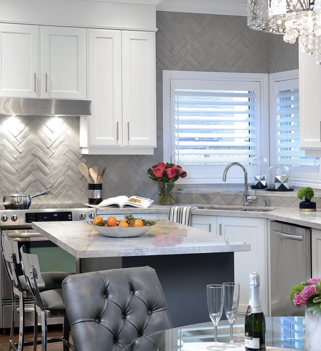 White Kitchen Featuring Grey Counters and Backsplash