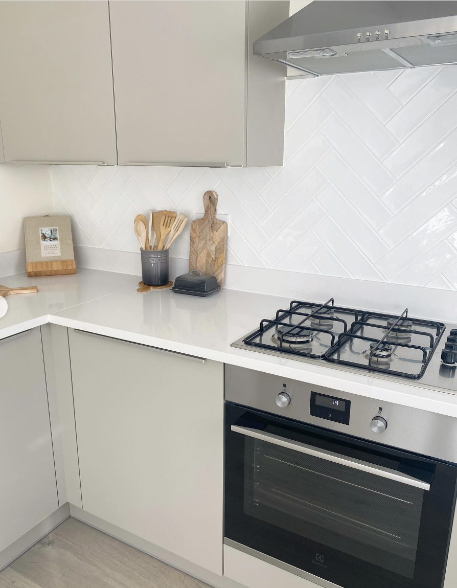 White Tile Backsplash With Off-White Cabinets