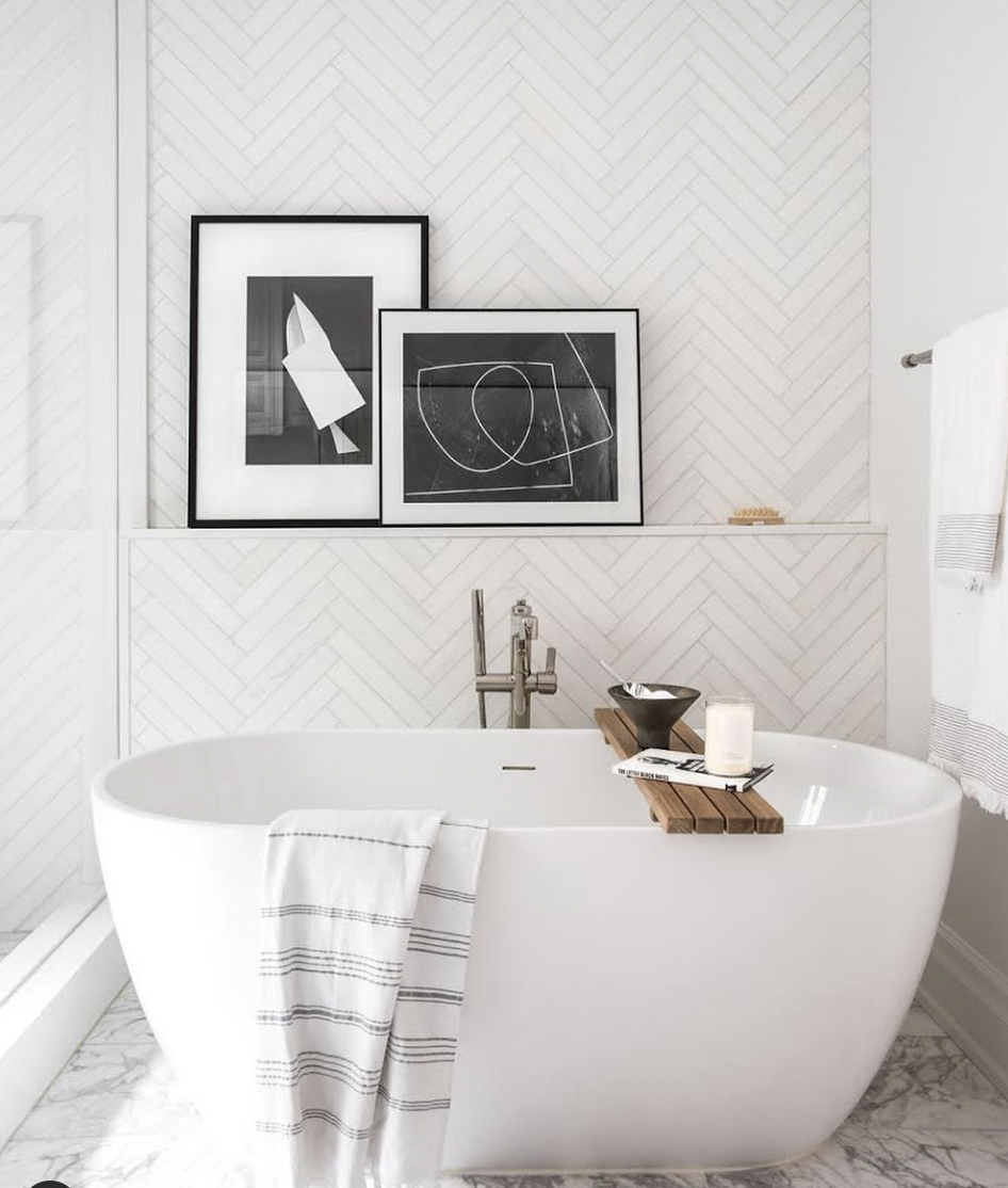 Bathroom With White Herringbone Tiles and a Bathtub