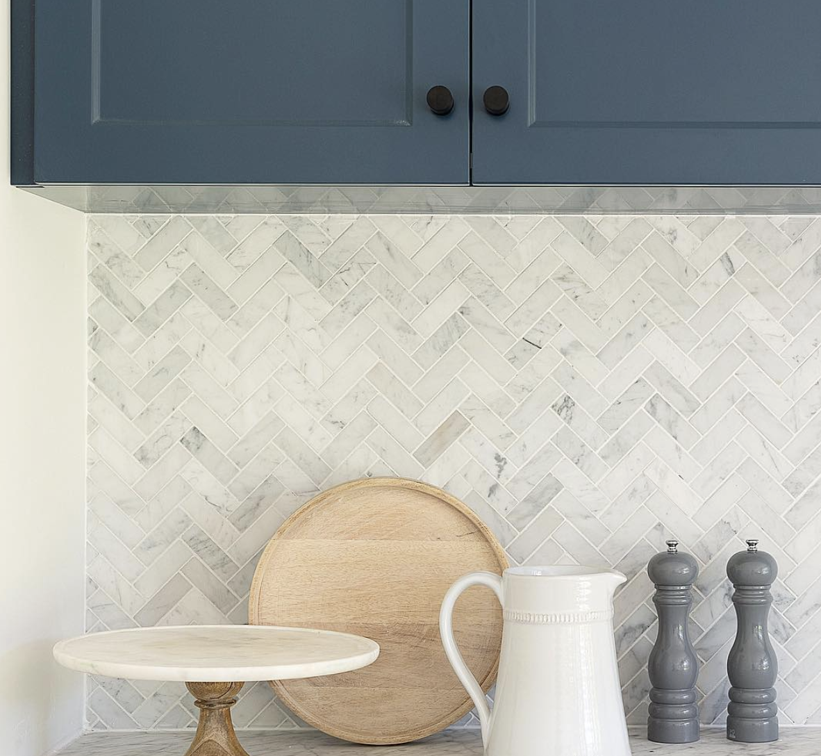 Blue Cabinet Kitchen With a Gray Herringbone Backsplash