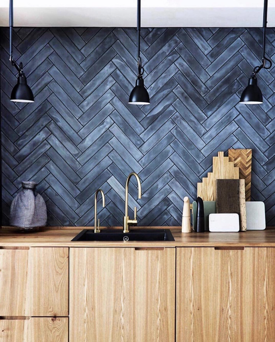 Dark Blue Backsplash in a Herringbone Pattern With Black Pendant Lights