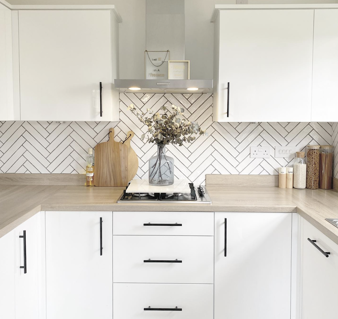 Wood Countertops With White Cabinets and Black Hardware