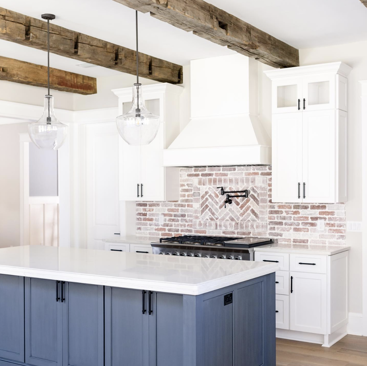 Brick Tile Backsplash in a White-Cabinet Kitchen