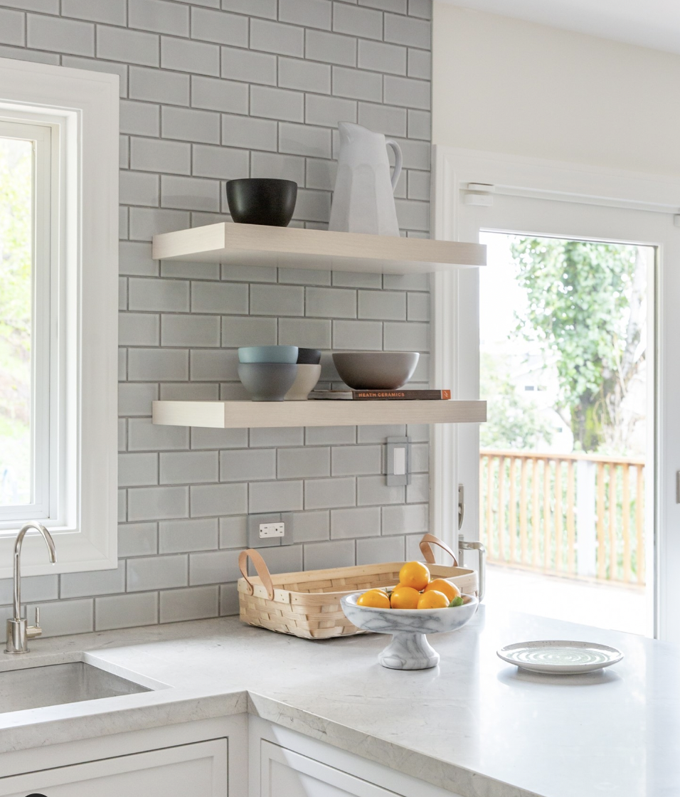 Gray Faux-Brick Wall With Shelves Above the Counter