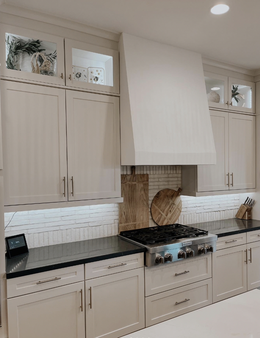 Kitchen With a Large Window, White Brick Backsplash, and Black Industrial Fixtures