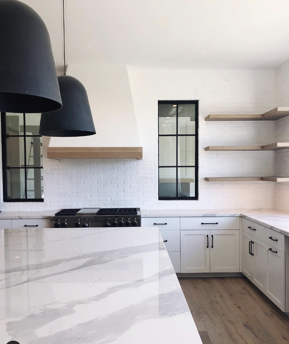 Kitchen With White Brick Backsplash And Black-Frame Window