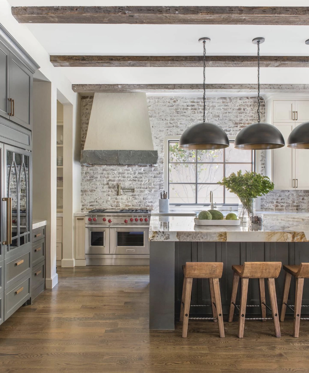 Red Brick Backsplashes Paired With Wood Beams And Dark Wood Floors