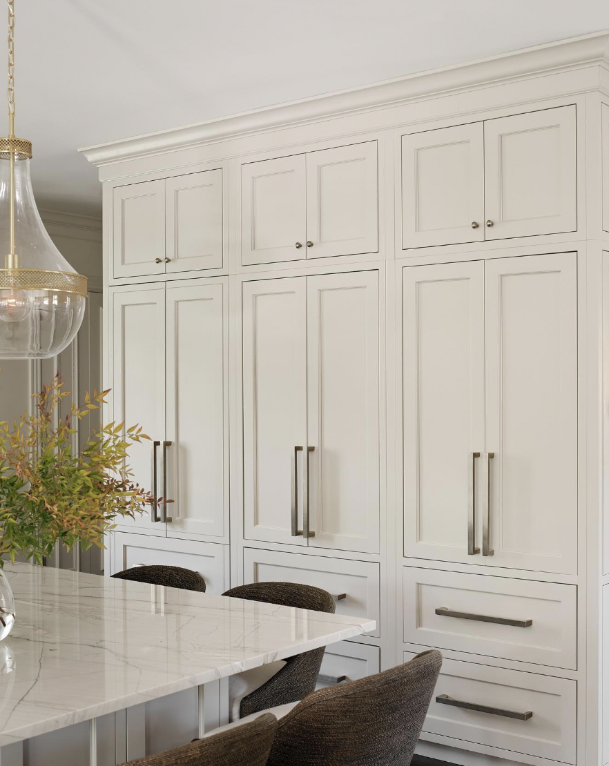 White Cabinetry with Silver Hardware and Crown Molding