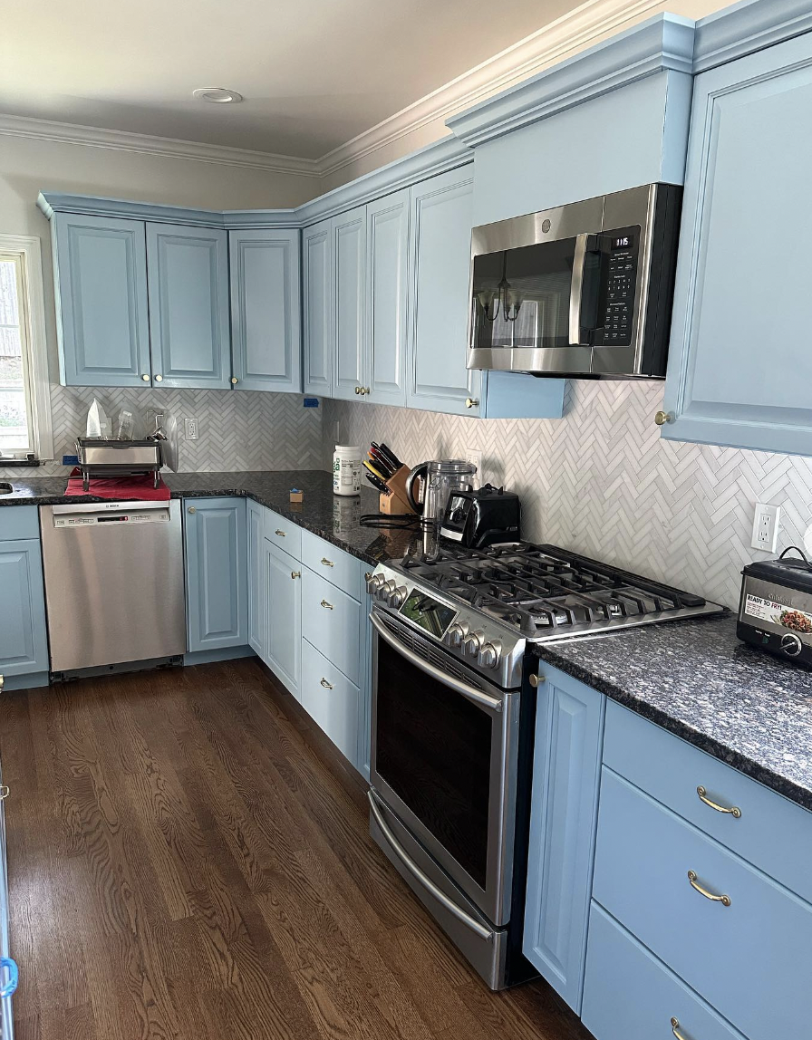 Blue Kitchen Cabinets Finished With Crown Trim and Granite Countertop