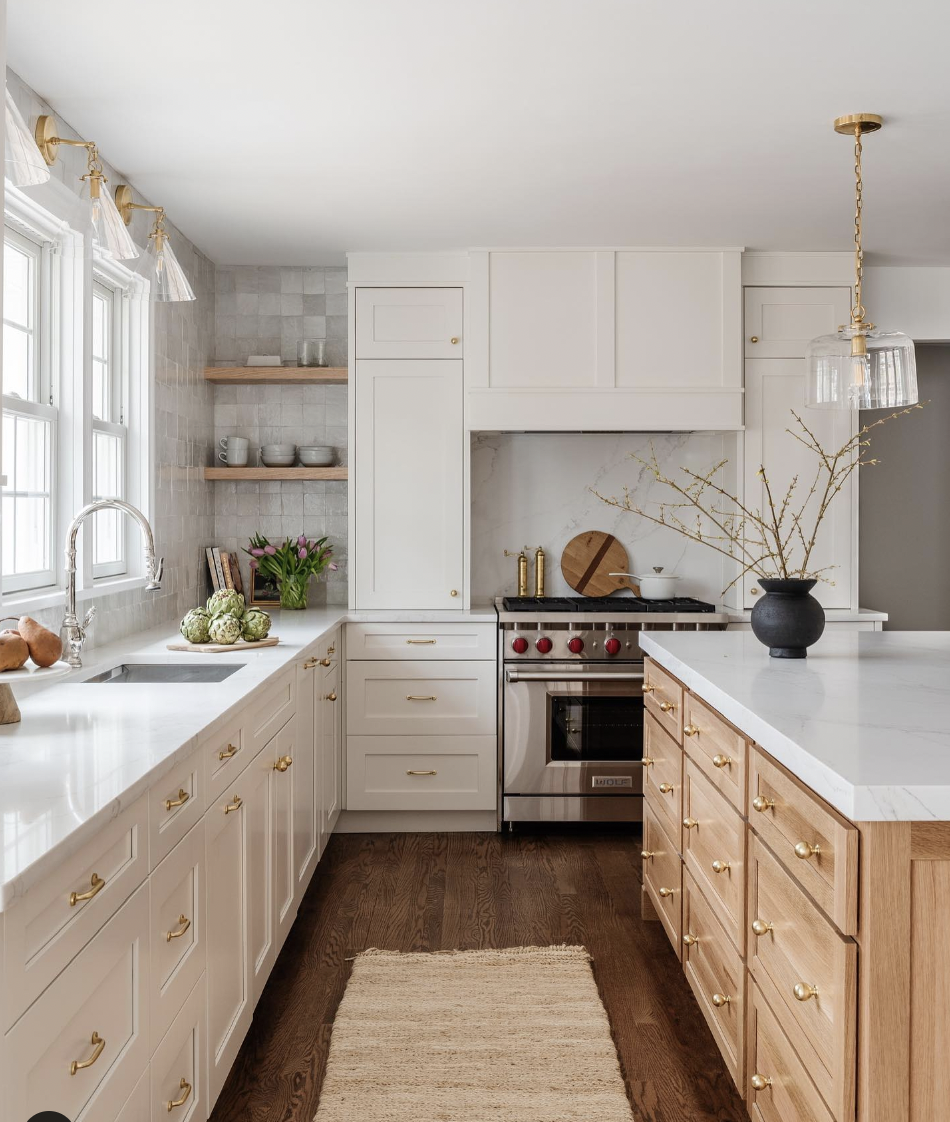 Gold and Glass Fixtures by a Windowed Kitchen Sink