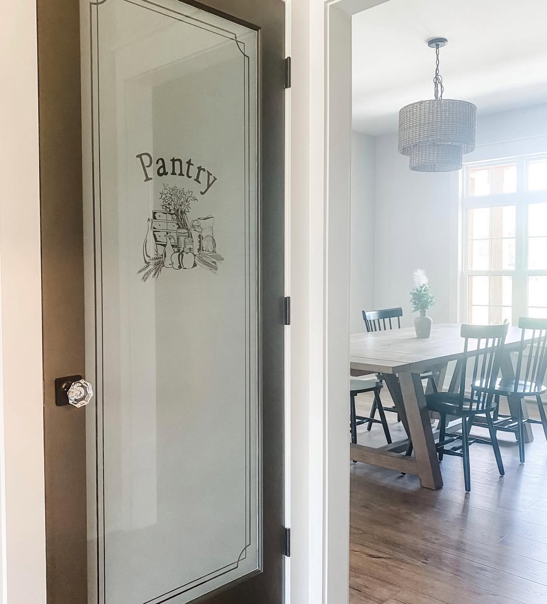 Farmhouse Pantry Featuring a Frosted Glass Door and Crystal Knob