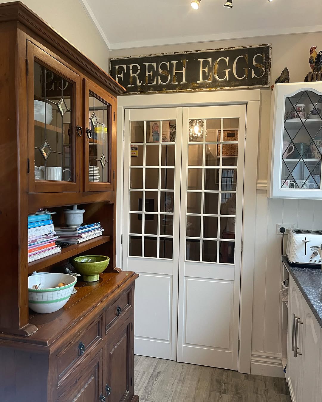 Farmhouse Kitchen With Glass Pantry Doors in White Frames
