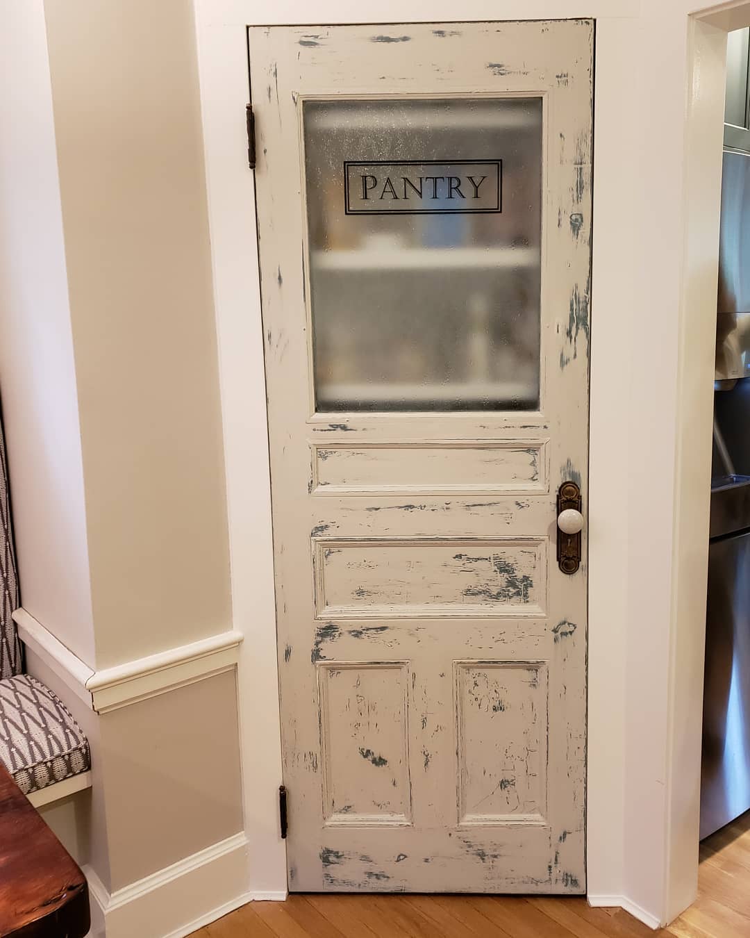 White Distressed Pantry Door With a Brass Knob
