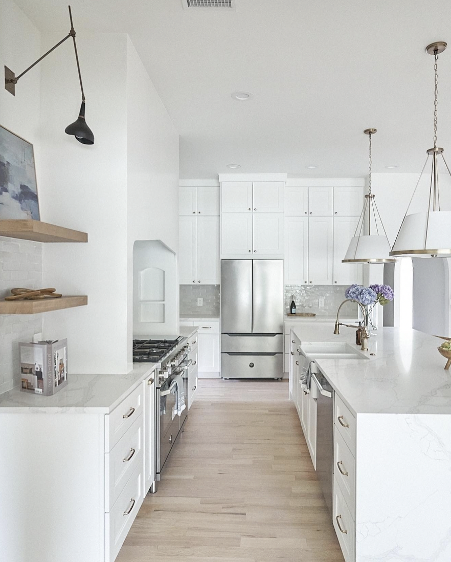 White Overlay Cabinetry on Pale Wood Floors